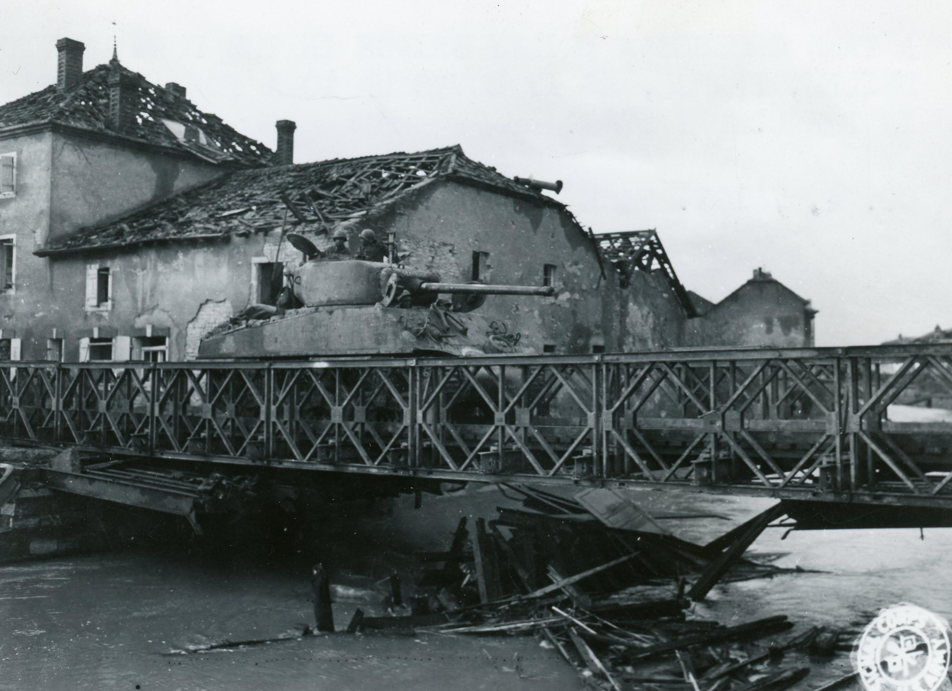 A tank of the 761st Tank Battalion is crossing a Bailey Bridge near the town of Vic-Sur-Seille, France, as it moves to the frontline.