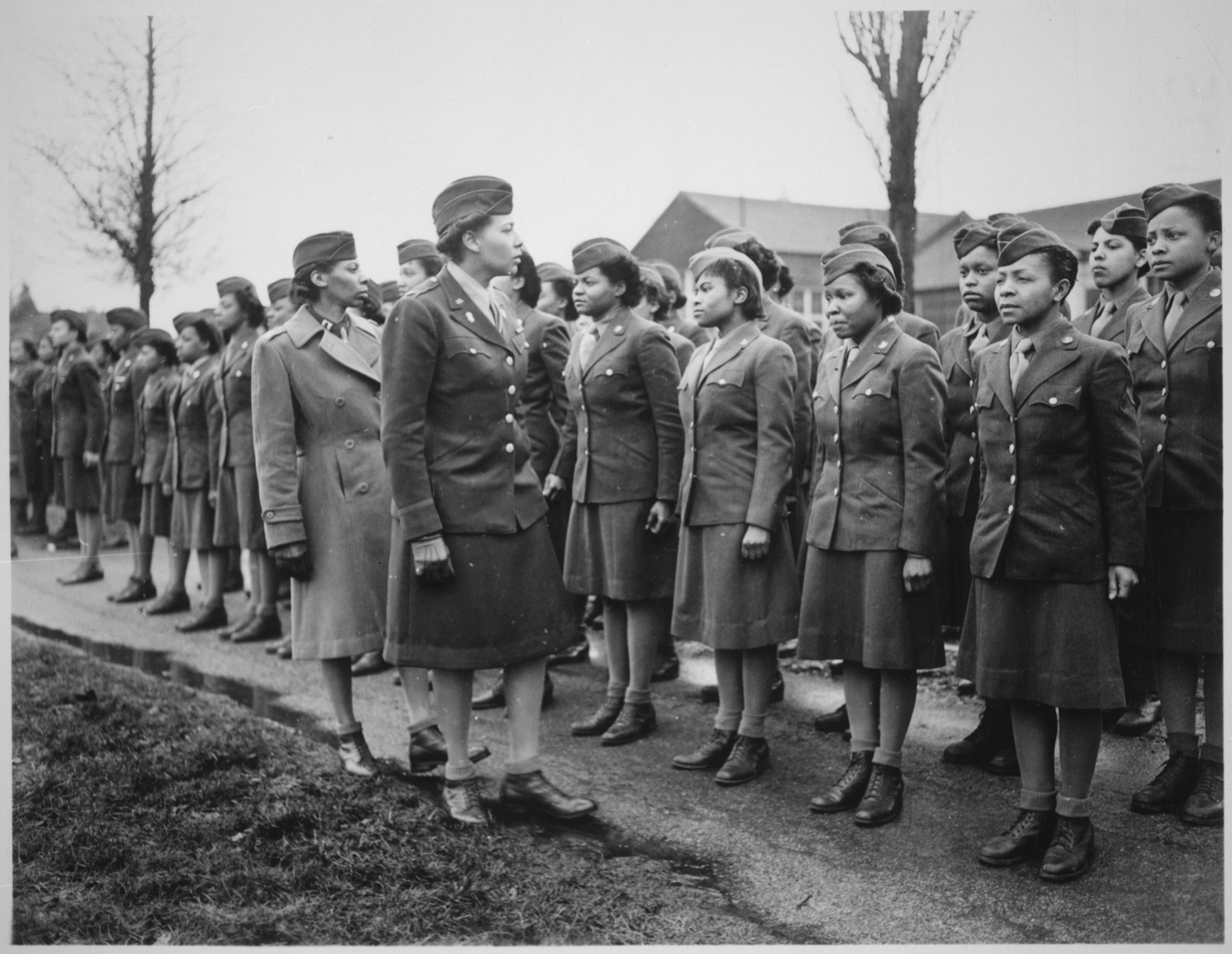 Women of the 6888th Central Postal Directory Battalion in England. In the middle is Major Charity Adams. She's inspecting the women under her command.