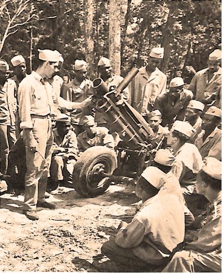 An image of Black American marines in training with a 75mm howitzer.