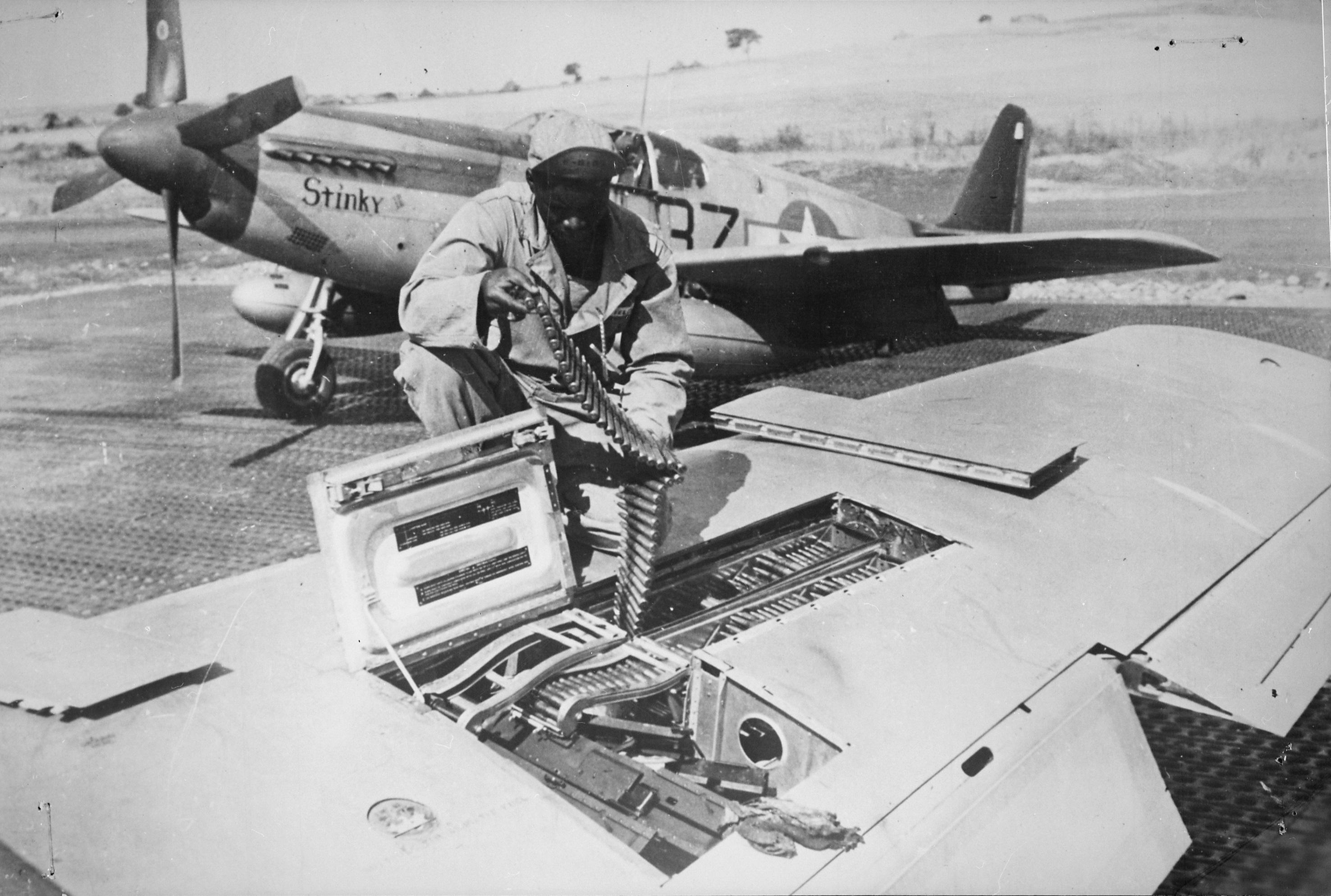 Historical image showing John T. Fields, an armorer with the 332nd Fighter Group of Black American soldiers during WWII