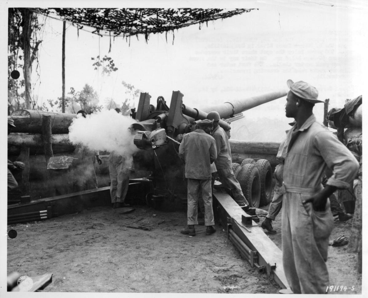 Historical image showing Battery B, 49th Coast Artillery, section 2, fires at Japanese positions on Bougainville of Black American soldiers during WWII