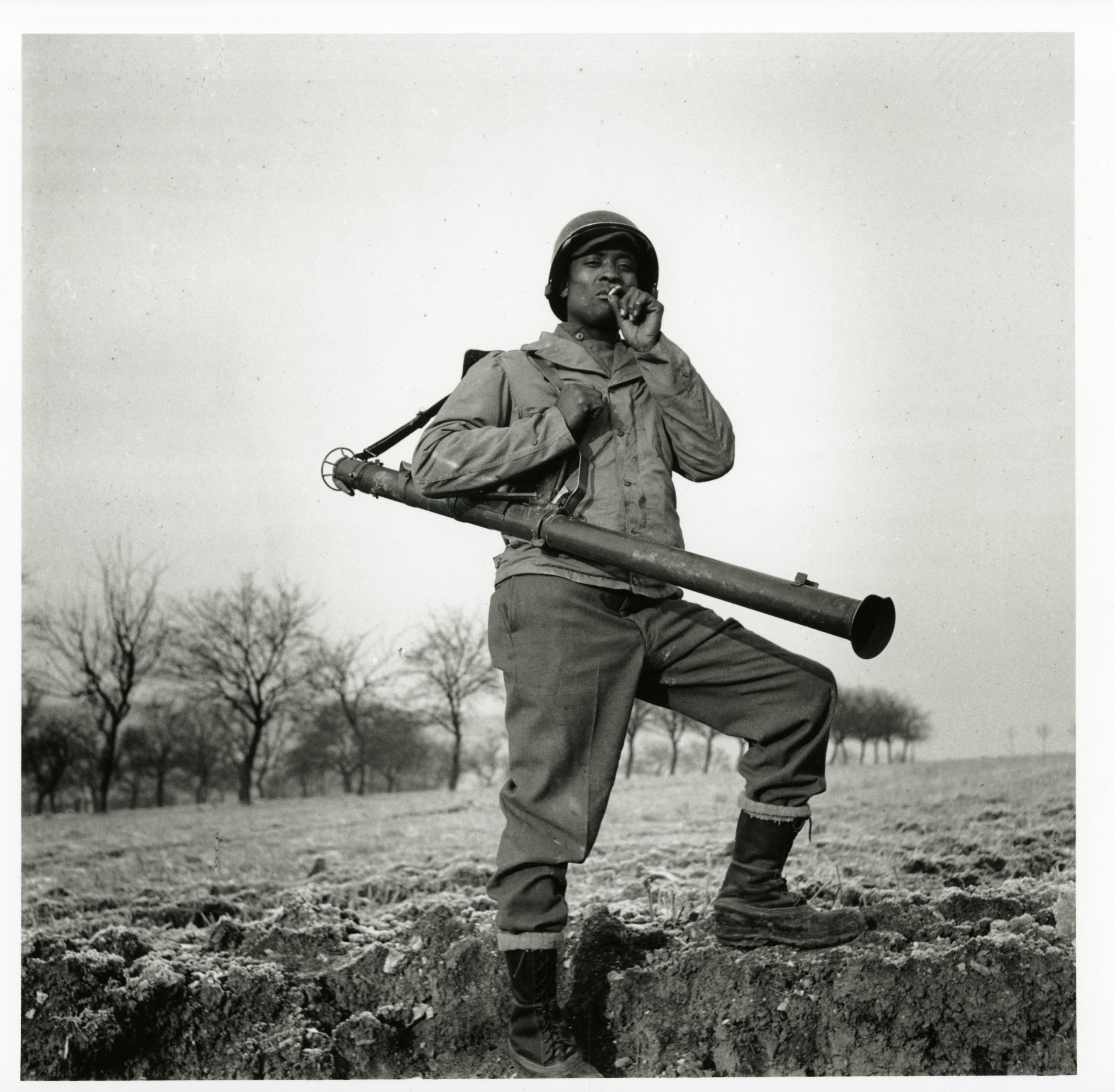 Historical image showing Charlie Rattler of the 614th Tank Destroyer Battalion is smoking a cigarette of Black American soldiers during WWII