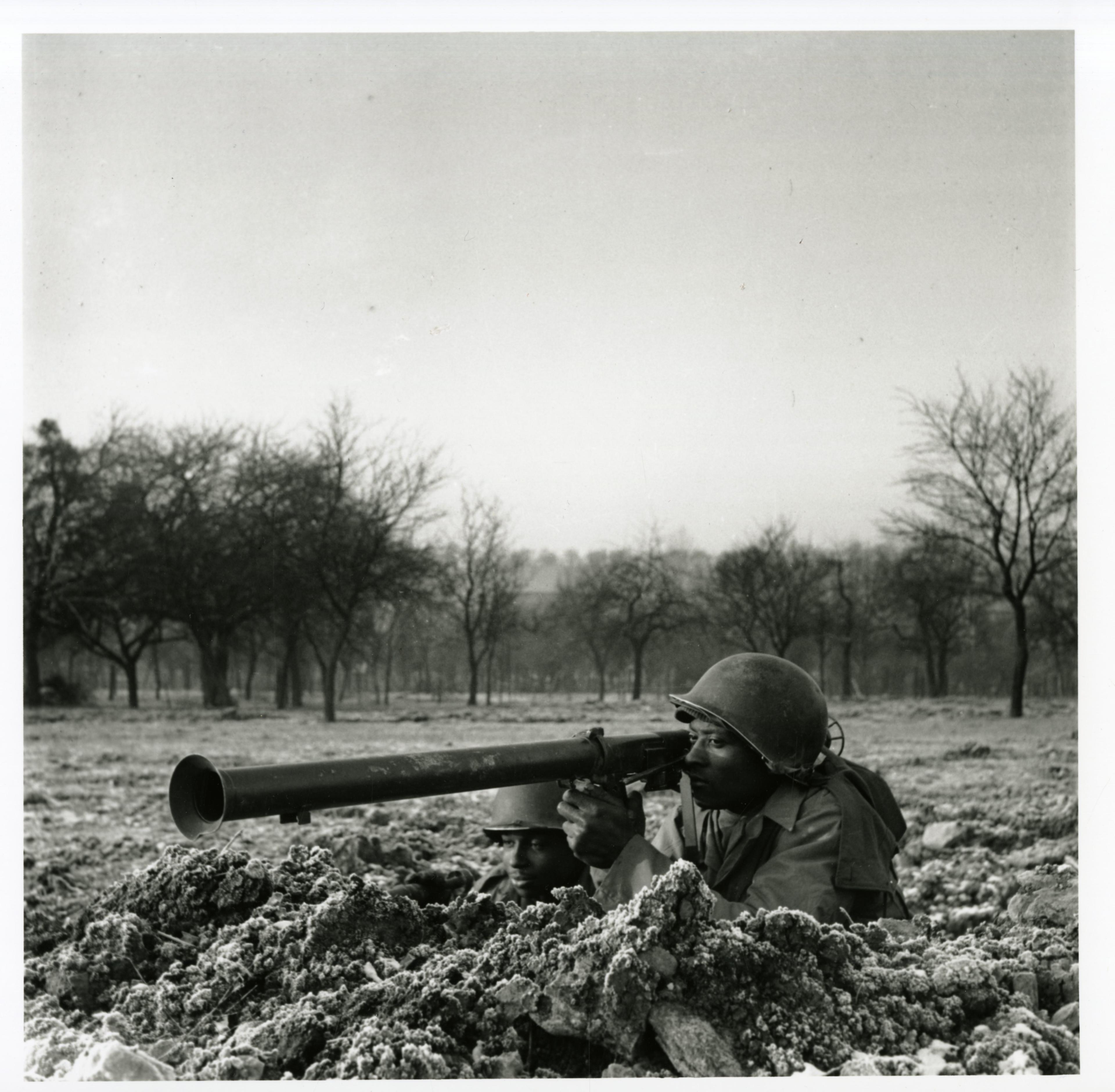 Historical image showing Charlie Rattler of the 614th Tank Destroyer Battalion in a foxhole with another soldier of Black American soldiers during WWII