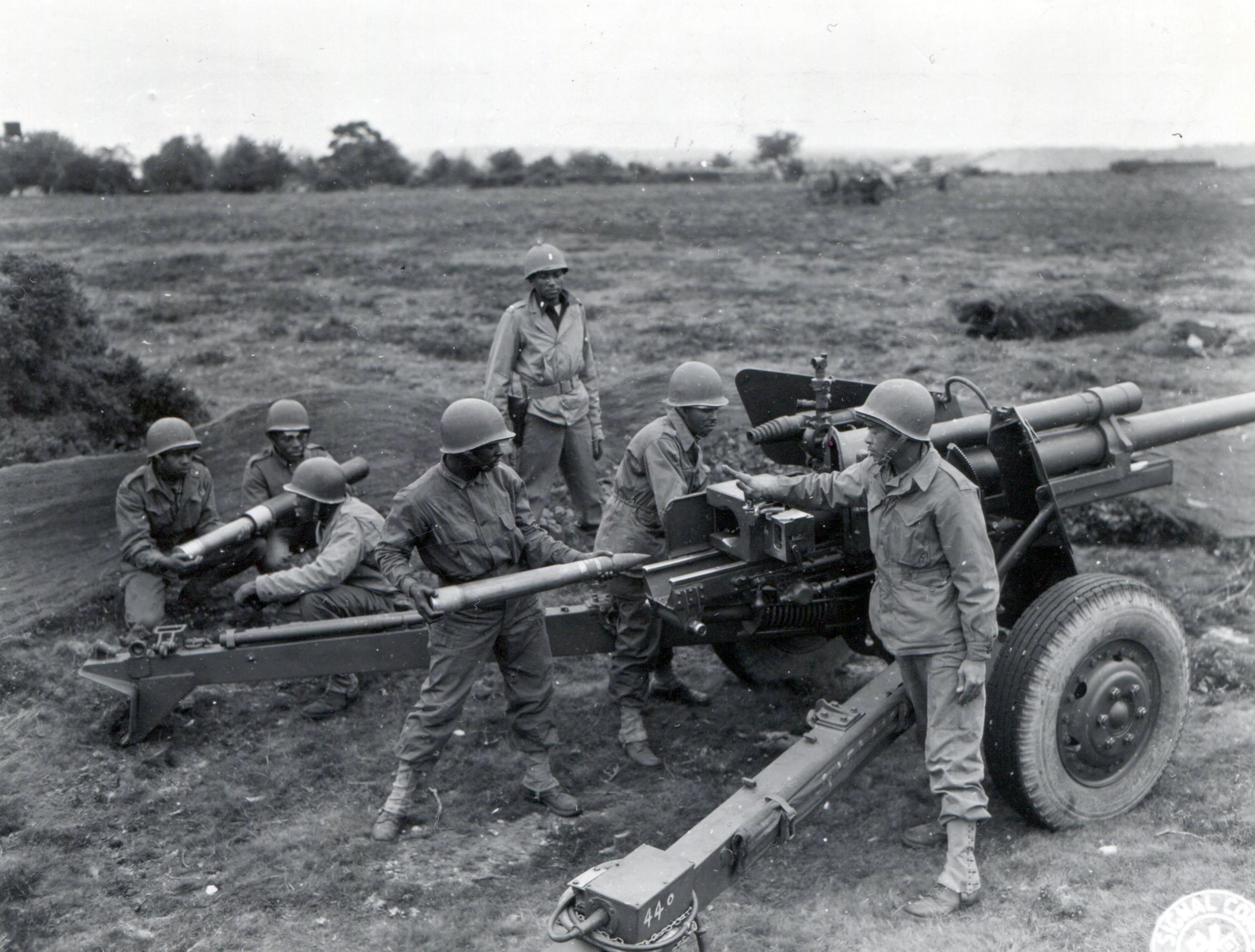 Historical image showing A three inch gun of the 614th Tank Destroyer Battalion during a firing exercise of Black American soldiers during WWII