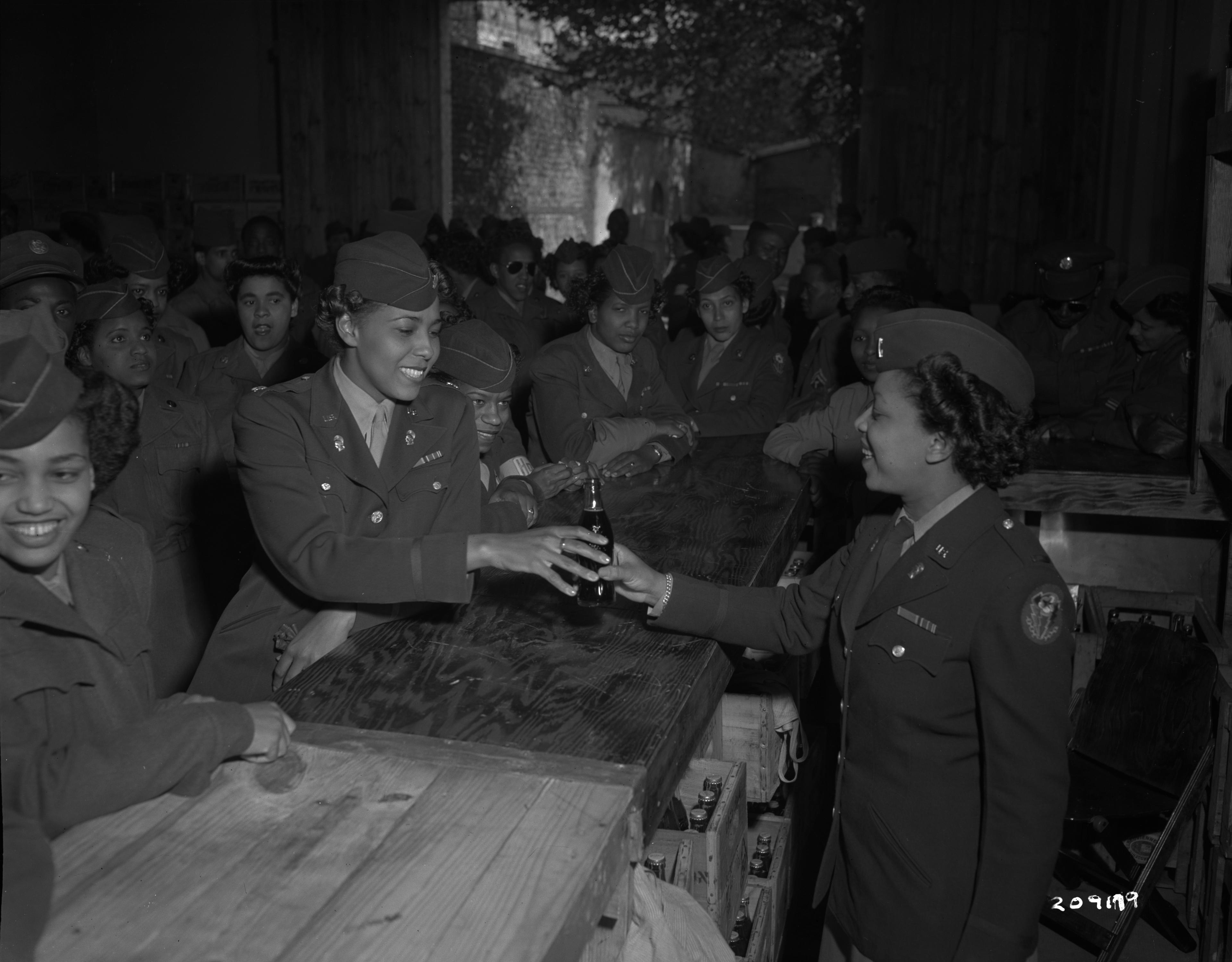 Historical image showing Opening of the 6888th Central Postal Directory Battalion bar in France of Black American soldiers during WWII