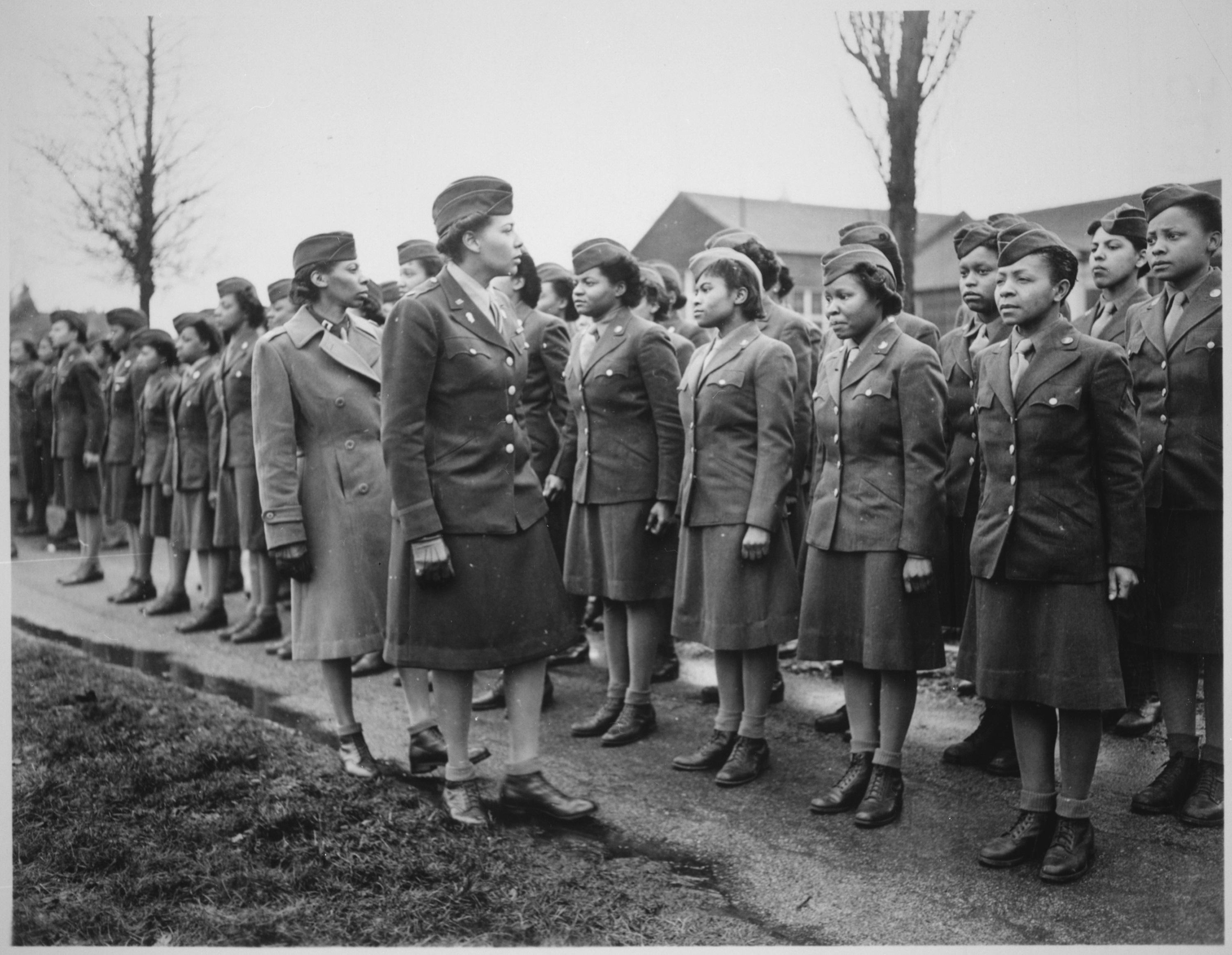 Historical image showing Major Charity Adams inspects the troops under her command of Black American soldiers during WWII