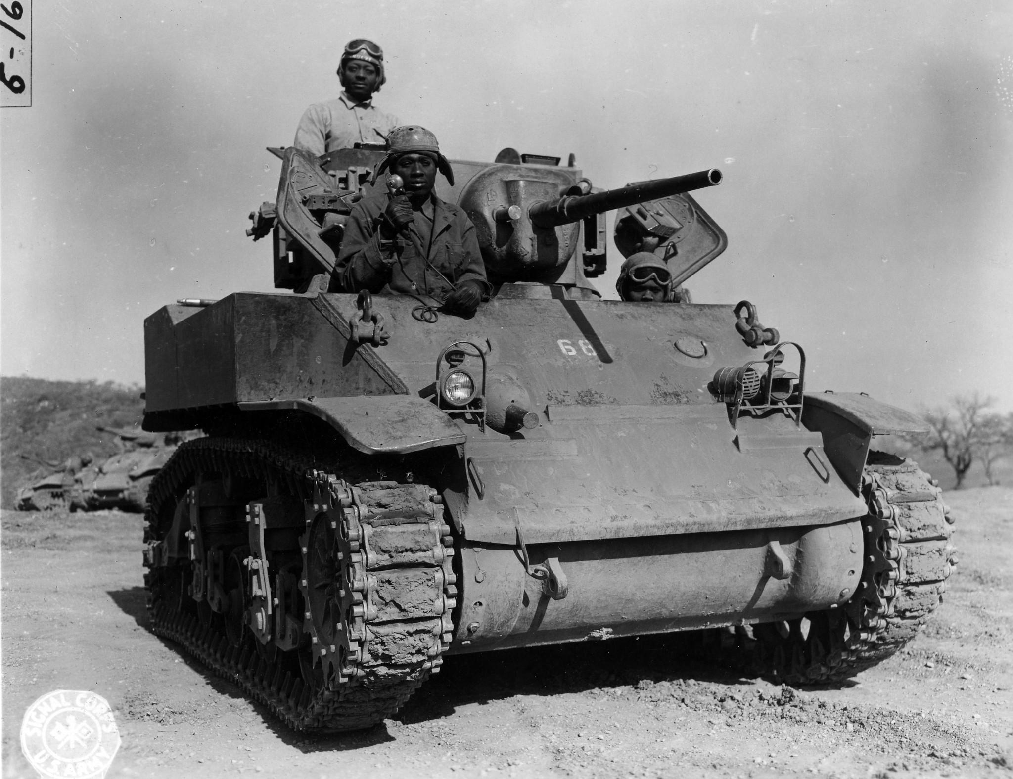 Historical image showing A light tank with Black American trainees of Black American soldiers during WWII