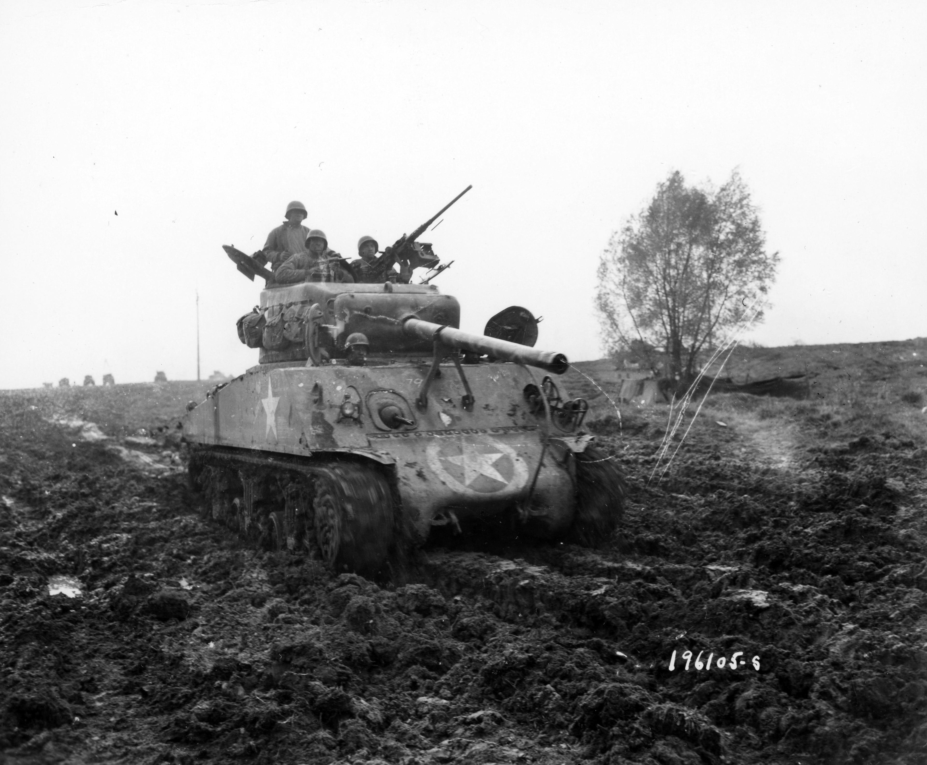 Historical image showing A M4 Sherman tank of the 761st Tank Battalion of Black American soldiers during WWII