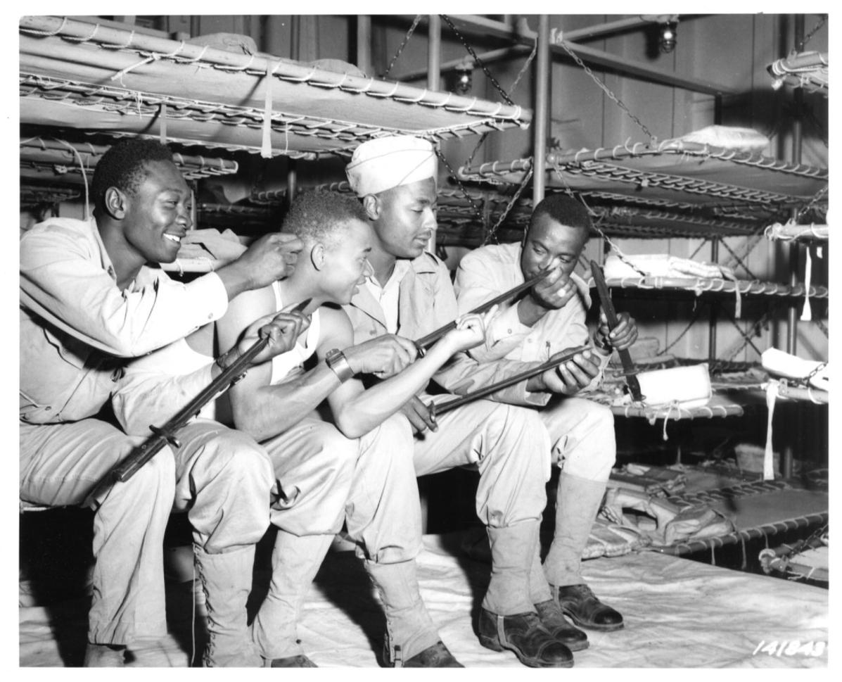 Historical image showing Soldiers of the 76th Coast Artillery Regiment show their bayonets of Black American soldiers during WWII