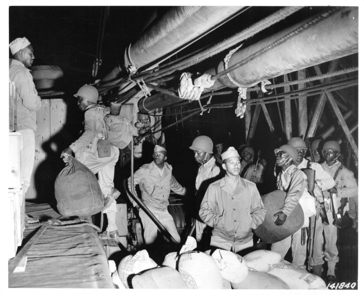 Historical image showing Soldiers of the 76th Coast Artillery on board of the SS Mormacsea of Black American soldiers during WWII