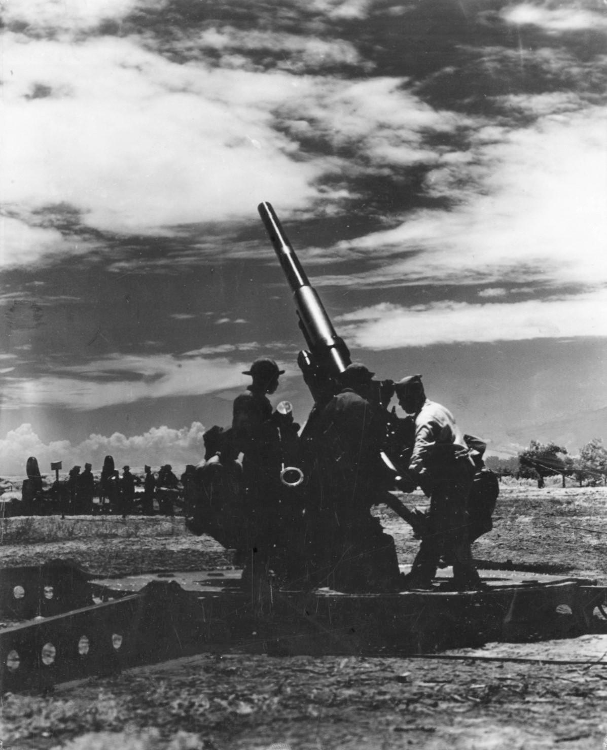 Historical image showing A 3-inch anti-aircraft gun of the 76th Coast Artillery Regiment of Black American soldiers during WWII