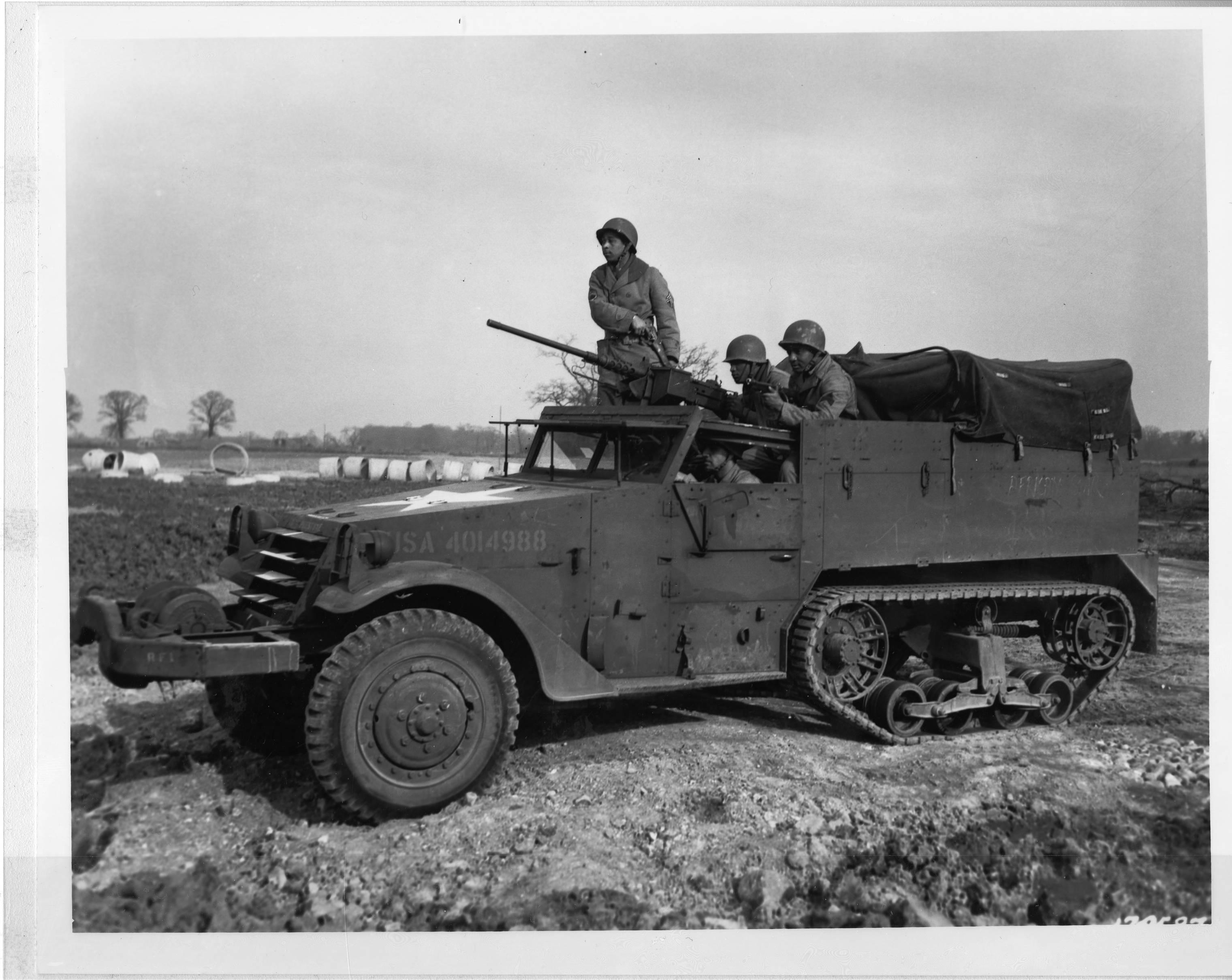 Historical image showing An armed halftrack of the 827th Engineers Aviation Battalion. of Black American soldiers during WWII